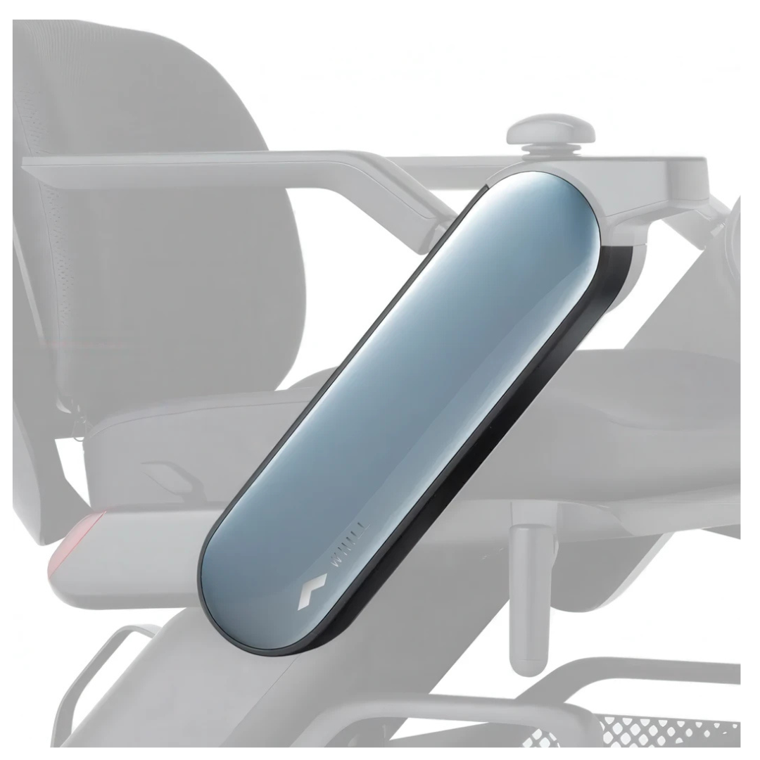 A close-up of sleek, metallic blue and black Arm Covers for WHILL Model C2 Power Chairs—showing their interchangeable design—stands out, with a softly blurred WHILL Model C2 in the background.